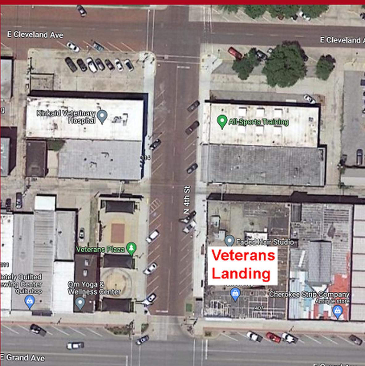 Aerial map with a red 'Veterans Landing' marker at 111 North 4th Street, Ponca City. It is on the east side of North 4th Street, one block south of East Cleveland Avenue and one block north of East Grand Avenue, directly across the street from Veterans Plaza and next to Faded Hair Studio.